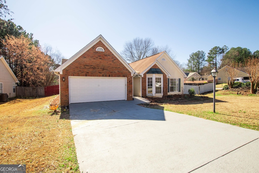 view of front of home with a front yard and central AC unit