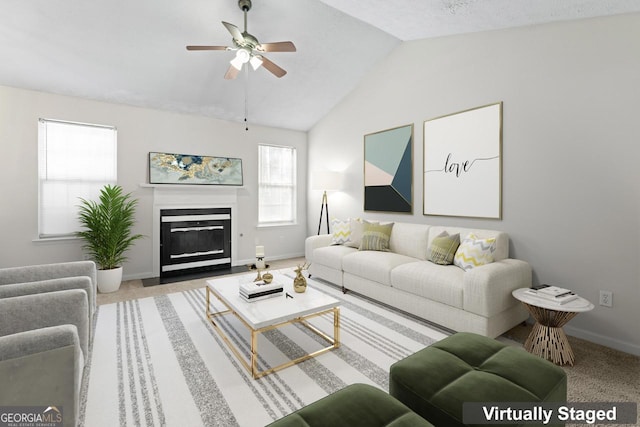 living room with ceiling fan, vaulted ceiling, and carpet