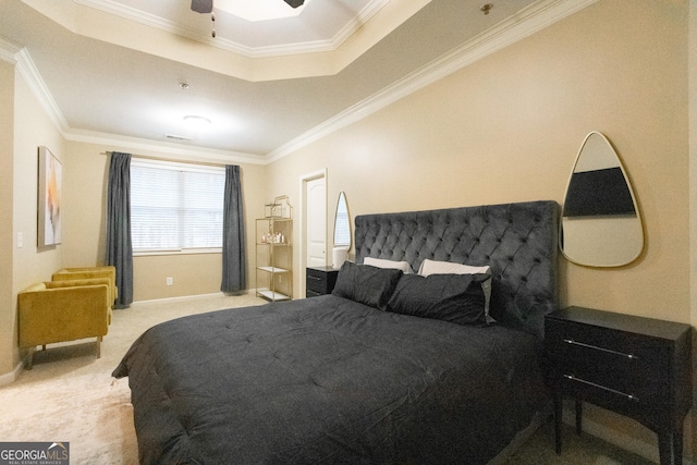 bedroom with a tray ceiling, crown molding, light colored carpet, and ceiling fan