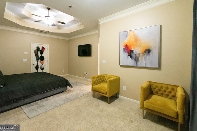 carpeted bedroom featuring a raised ceiling, ornamental molding, and ceiling fan