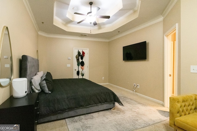 bedroom featuring crown molding, light colored carpet, a raised ceiling, and ceiling fan