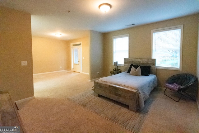 bedroom featuring carpet floors and multiple windows