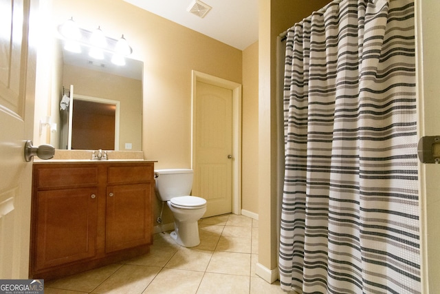 bathroom featuring tile patterned flooring, vanity, and toilet