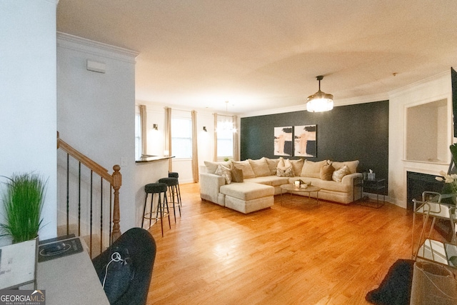 living room featuring crown molding and wood-type flooring