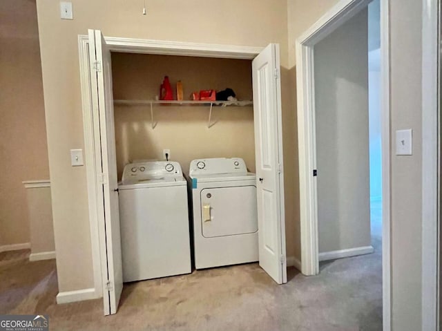 laundry room featuring light colored carpet and washing machine and dryer