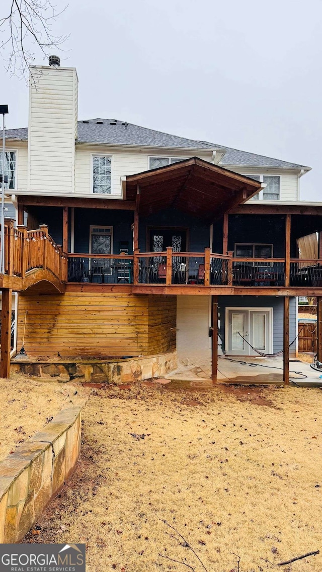 rear view of property featuring a patio area