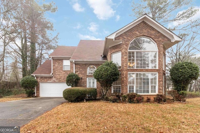 front facade featuring a garage and a front yard