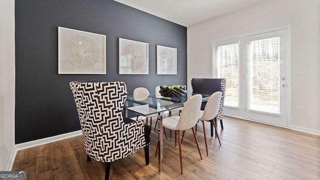 dining space featuring wood-type flooring