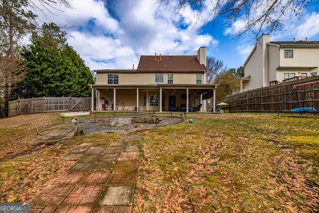 rear view of property with a yard and a patio area