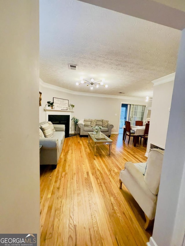 6594 Meadow Green Cir, Peachtree Corners, GA 30092 - living room featuring ornamental molding, wood-type flooring, and a textured ceiling