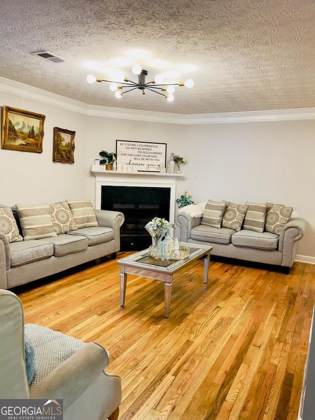 6594 Meadow Green Cir, Peachtree Corners, GA 30092 - living room with a chandelier, crown molding, wood finished floors, and a textured ceiling