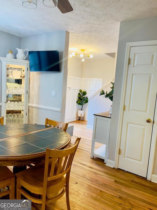 6594 Meadow Green Cir, Peachtree Corners, GA 30092 - dining space with a textured ceiling, light wood-style flooring, and ceiling fan