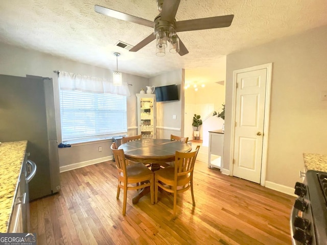 6594 Meadow Green Cir, Peachtree Corners, GA 30092 - dining space featuring ceiling fan, a textured ceiling, hardwood / wood-style floors, and baseboards