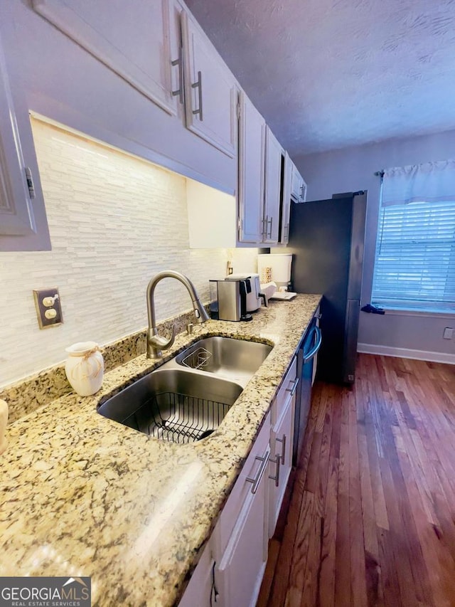 6594 Meadow Green Cir, Peachtree Corners, GA 30092 - kitchen with a sink, dark wood-type flooring, baseboards, tasteful backsplash, and light stone countertops