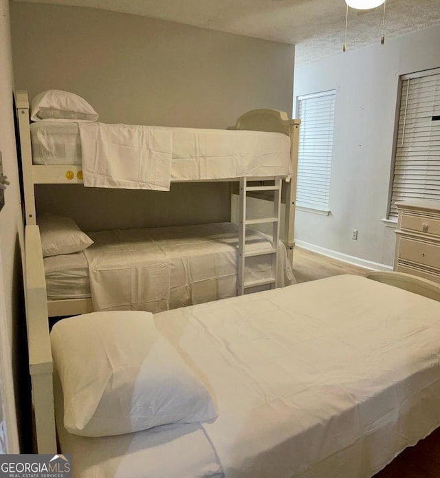 6594 Meadow Green Cir, Peachtree Corners, GA 30092 - bedroom featuring baseboards and wood finished floors
