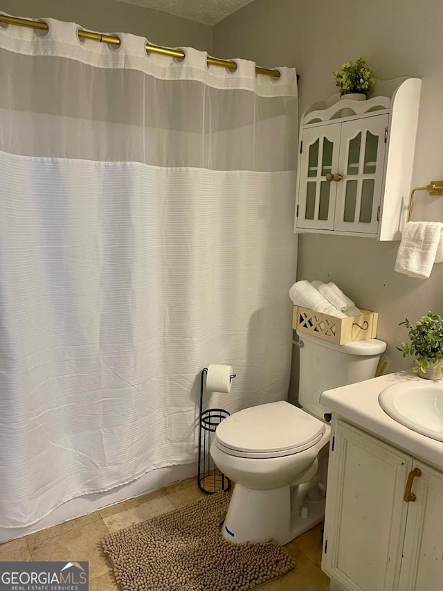 6594 Meadow Green Cir, Peachtree Corners, GA 30092 - full bathroom featuring vanity, toilet, tile patterned floors, and a shower with curtain