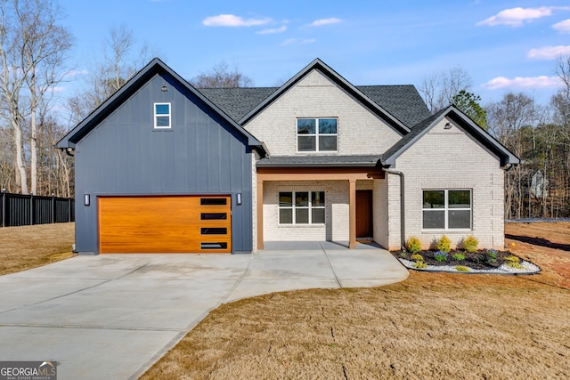 view of front of house featuring a garage and a front lawn