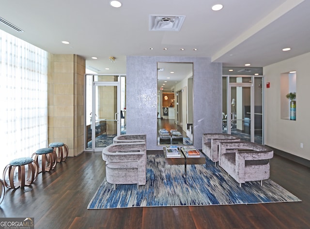 living room with a wall of windows and dark hardwood / wood-style floors