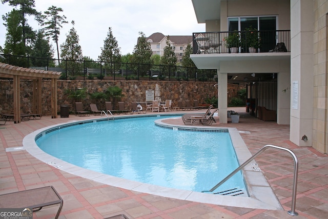 view of swimming pool with a pergola and a patio area