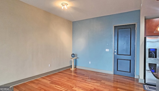 spare room with hardwood / wood-style floors