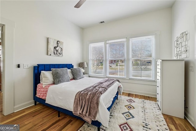 bedroom with wood-type flooring and ceiling fan