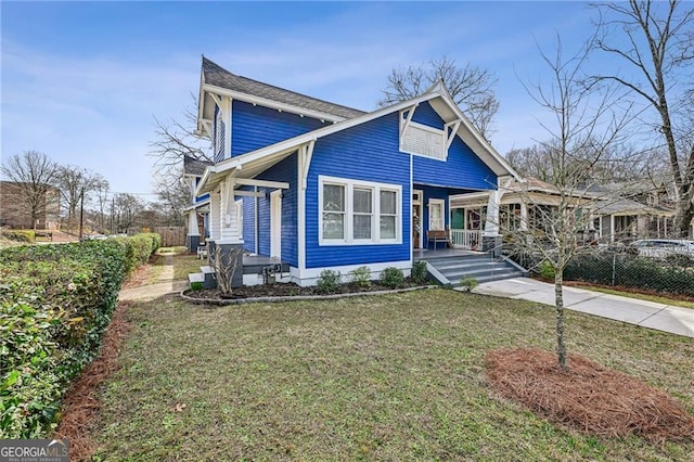 view of front of house featuring a porch and a front yard