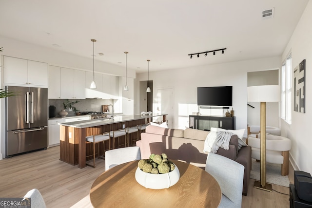 dining room featuring visible vents and light wood-style floors