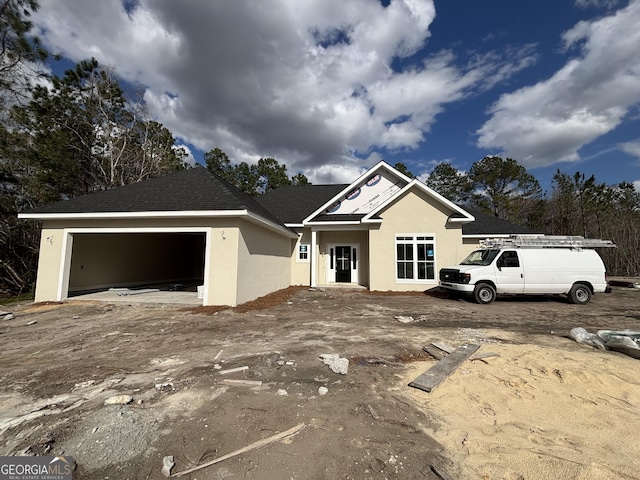 view of front of home with a garage and stucco siding