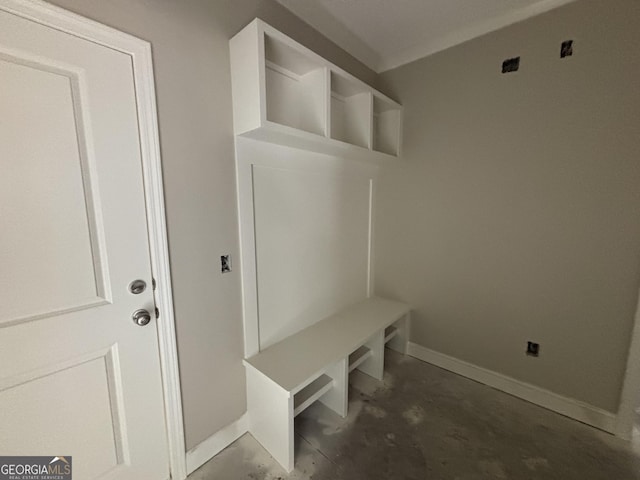 mudroom with baseboards and unfinished concrete flooring