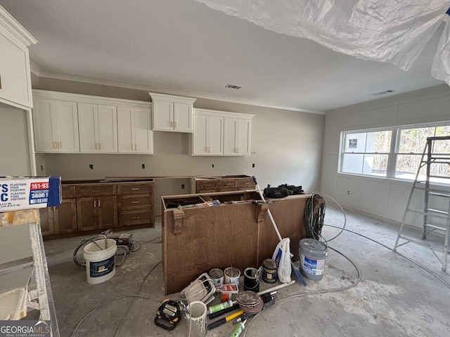 kitchen with visible vents and white cabinets