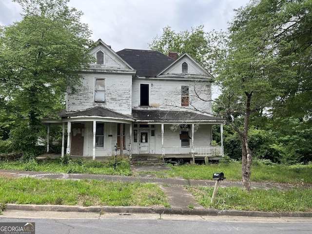 108 E 10th St SW, Rome, GA 30161 - view of front of home with a porch, a chimney, and roof with shingles