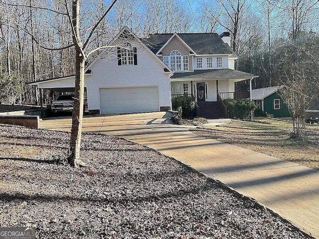 view of front of house with a garage, a porch, and a carport