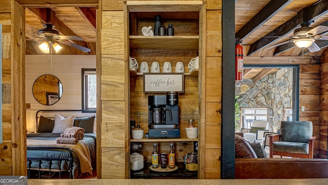 bedroom with beamed ceiling and wood walls