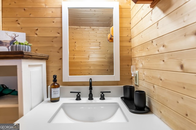 bathroom featuring vanity and wooden walls