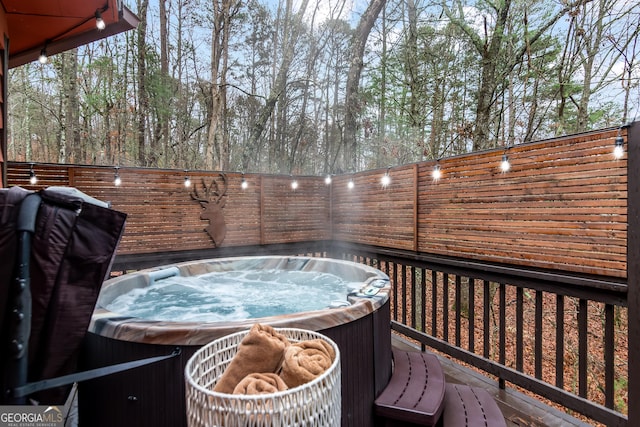 wooden terrace with a hot tub