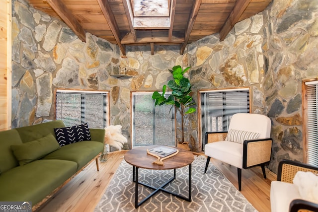 living room featuring hardwood / wood-style floors, beamed ceiling, and wood ceiling