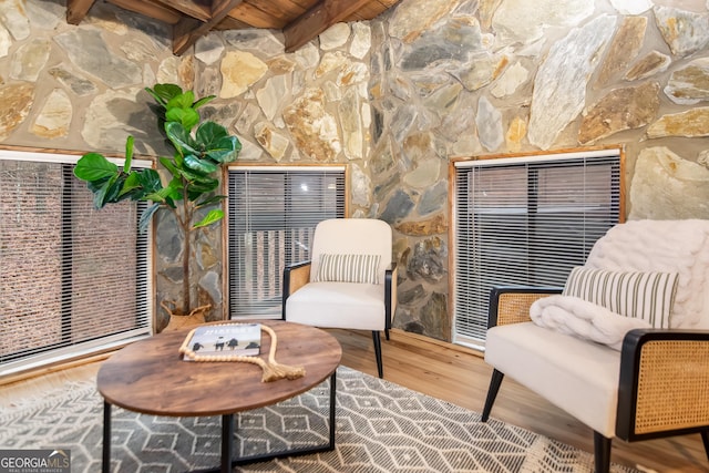 sitting room featuring hardwood / wood-style flooring, beam ceiling, and wooden ceiling