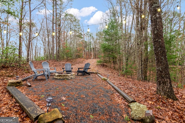 view of yard with an outdoor fire pit