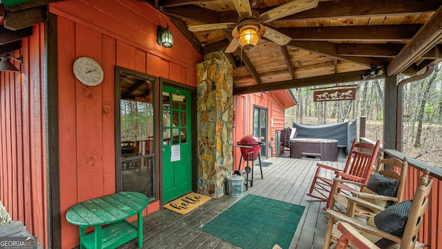 wooden deck featuring a hot tub