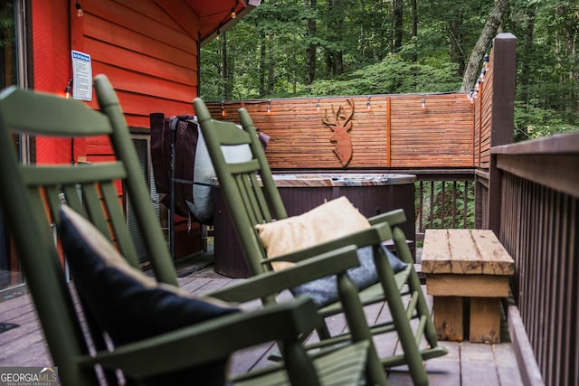 wooden terrace featuring a hot tub