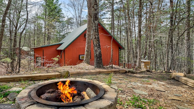 view of outbuilding with an outdoor fire pit