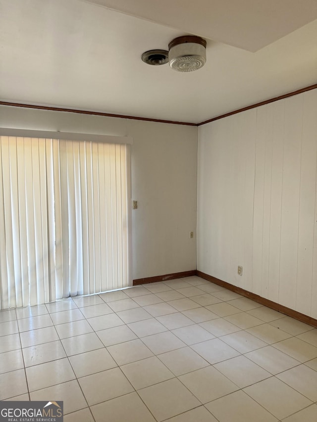 empty room featuring crown molding