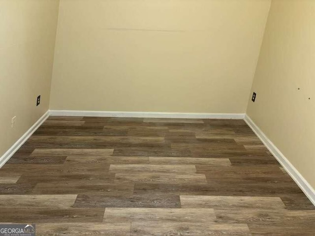 unfurnished room featuring dark hardwood / wood-style flooring