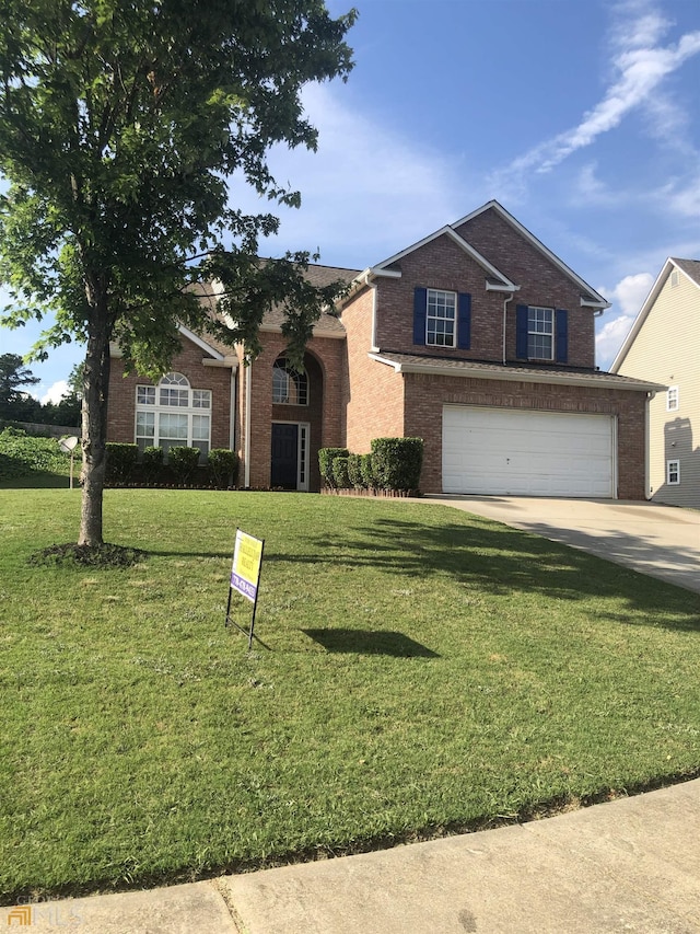 view of front of house featuring a garage and a front yard