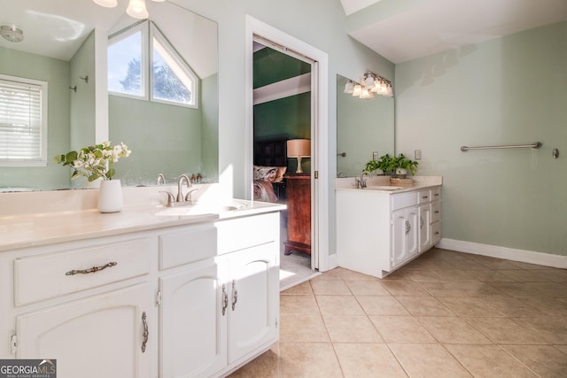 bathroom with vanity, tile patterned flooring, and vaulted ceiling