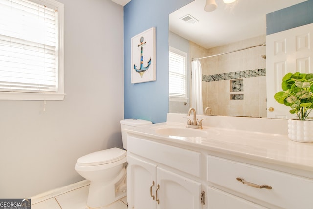 bathroom featuring toilet, tile patterned flooring, vanity, and walk in shower