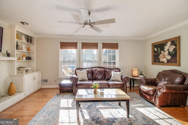 living room featuring light hardwood / wood-style floors, ceiling fan, and ornamental molding