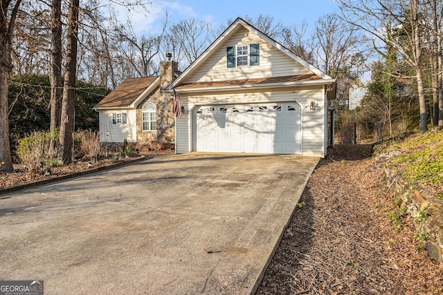 view of front of property featuring driveway and a chimney