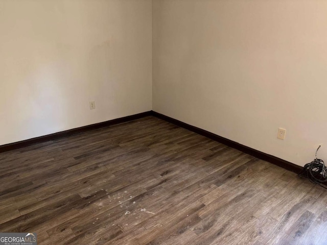 unfurnished room featuring dark hardwood / wood-style flooring