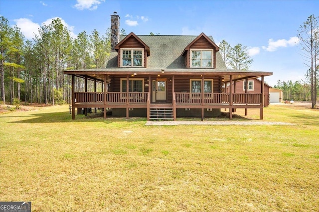 back of property with a yard and a garage